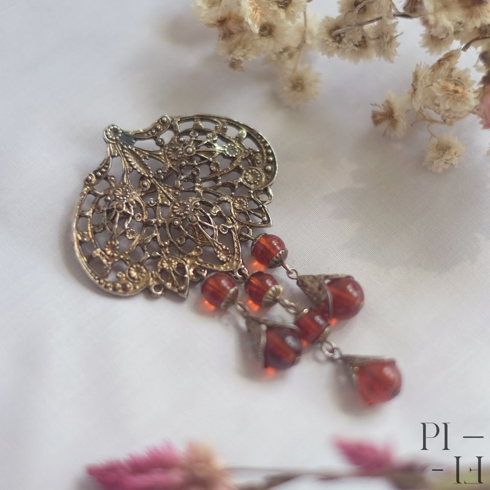 Vintage bronze and red brooch